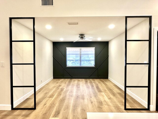 interior space with light wood-type flooring and ceiling fan