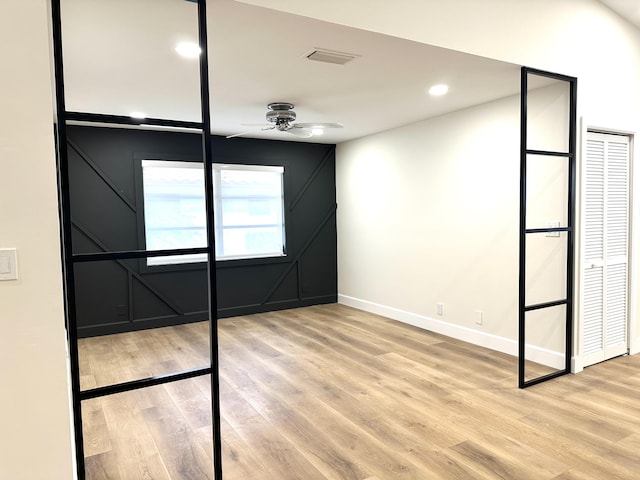 spare room featuring baseboards, visible vents, a ceiling fan, light wood-type flooring, and recessed lighting