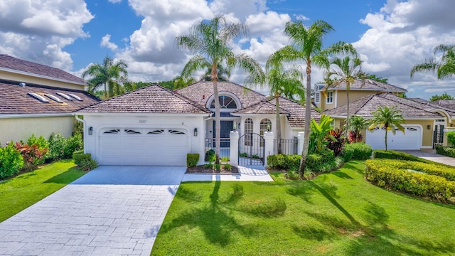 mediterranean / spanish-style home with a garage and a front yard