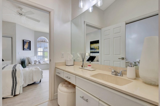 bathroom with hardwood / wood-style flooring, vanity, and ceiling fan