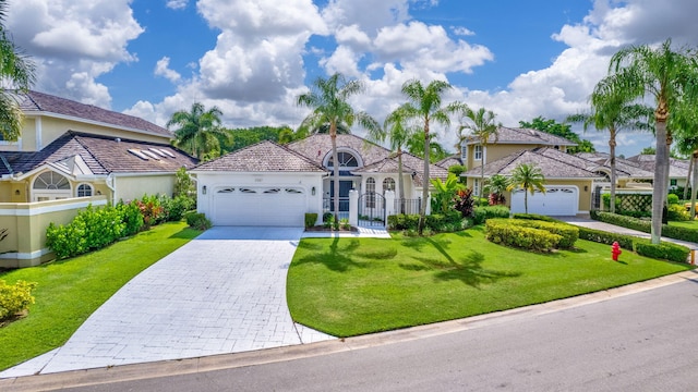 mediterranean / spanish house with a garage and a front yard