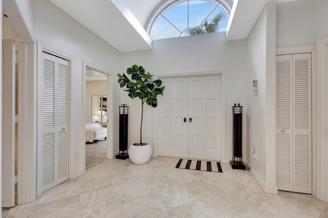 tiled foyer entrance featuring a skylight