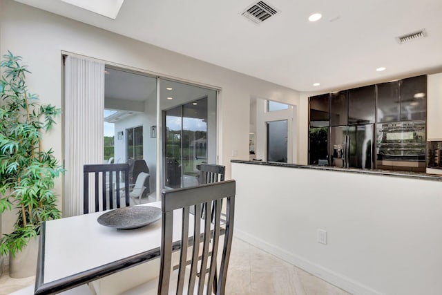 tiled dining space with a skylight