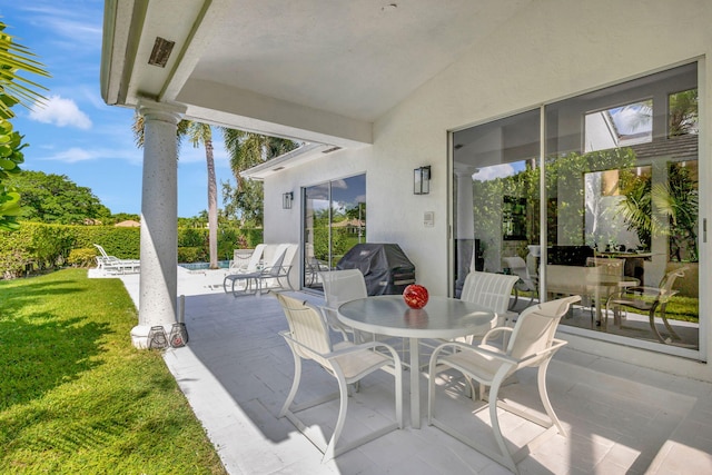 view of patio featuring a grill