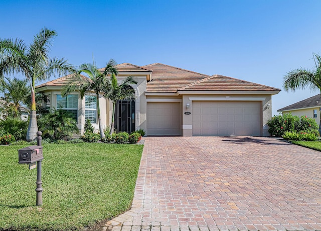 view of front facade with a garage and a front yard