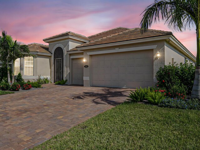 view of front of house featuring a garage and a front lawn