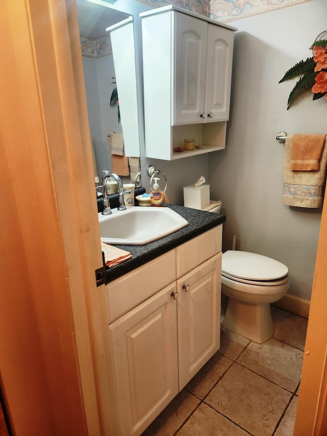 bathroom with tile patterned floors, vanity, and toilet