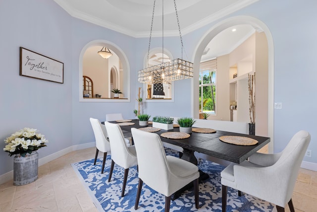 dining space with ornamental molding, an inviting chandelier, and light tile patterned floors