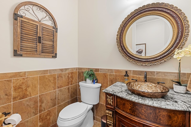 bathroom featuring tile walls, decorative backsplash, vanity, and toilet