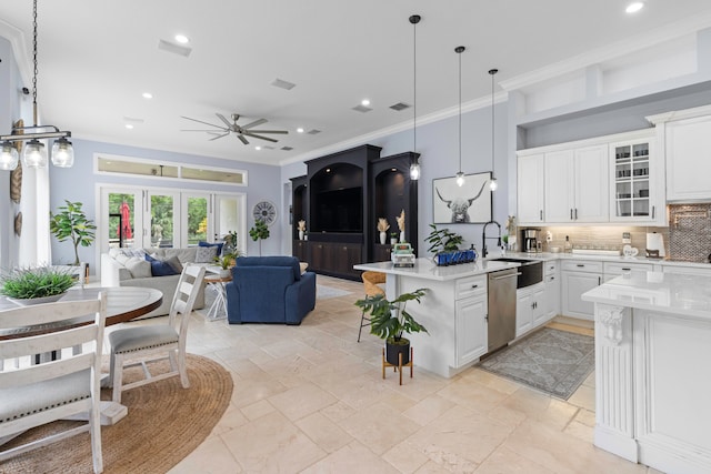 kitchen featuring dishwasher, pendant lighting, white cabinetry, and tasteful backsplash