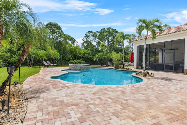 view of pool with an in ground hot tub, a patio, a sunroom, and ceiling fan