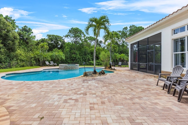 view of swimming pool with an in ground hot tub and a patio