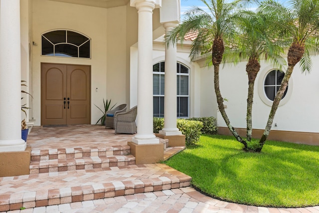 entrance to property with a lawn