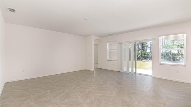 unfurnished room featuring light tile patterned floors