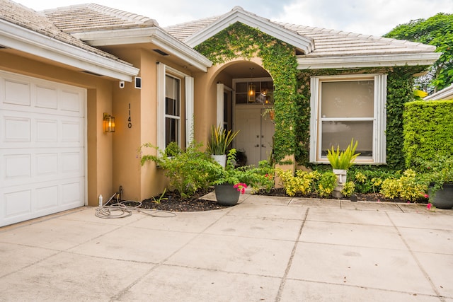 view of exterior entry with a garage