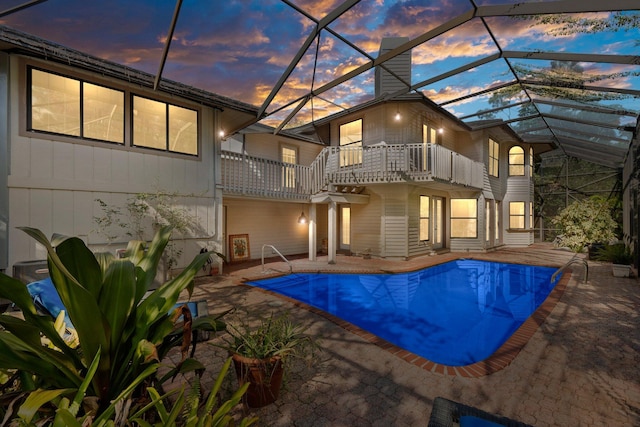 outdoor pool with a lanai and a patio