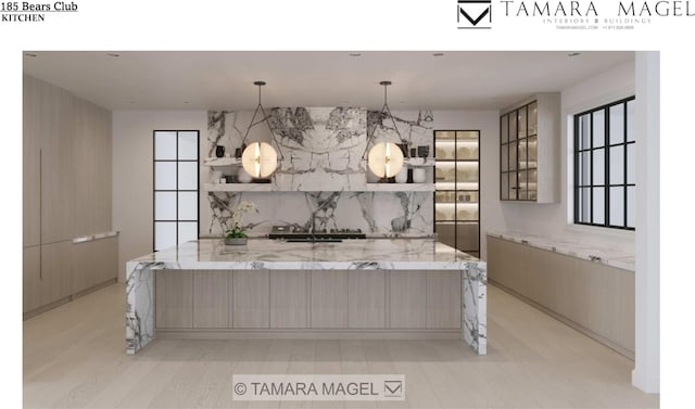 kitchen featuring pendant lighting, tasteful backsplash, light brown cabinetry, and light stone counters