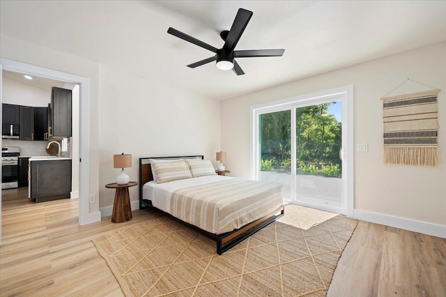 bedroom with light wood-type flooring, access to outside, and ceiling fan