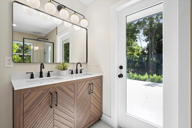 bathroom featuring a healthy amount of sunlight and vanity