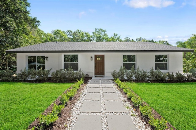 ranch-style home featuring a front yard