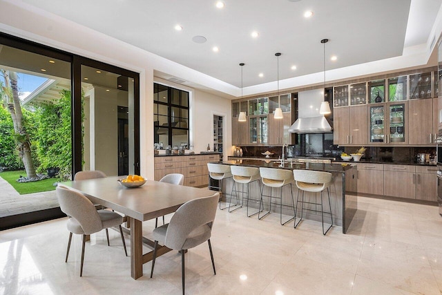 dining room featuring recessed lighting and a tray ceiling