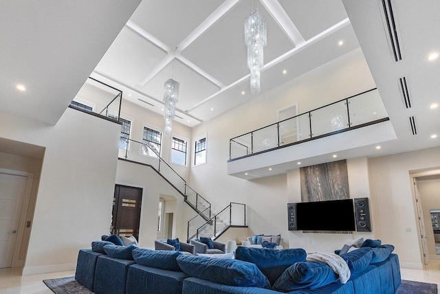 living area with a towering ceiling, recessed lighting, baseboards, coffered ceiling, and stairs