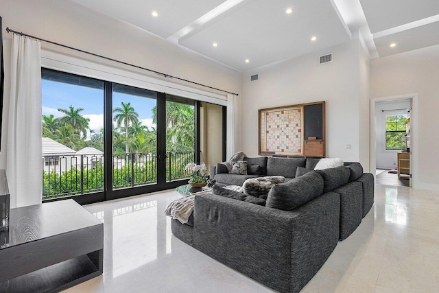 living room with visible vents, recessed lighting, beamed ceiling, and a high ceiling