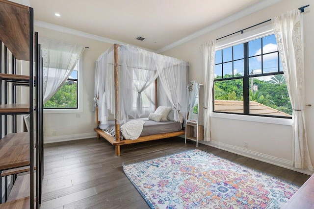 bedroom with baseboards, crown molding, recessed lighting, and dark wood-style flooring