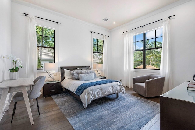 bedroom with visible vents, recessed lighting, dark wood-style floors, and ornamental molding