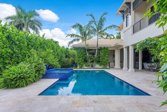 view of swimming pool featuring a patio area and a pool with connected hot tub