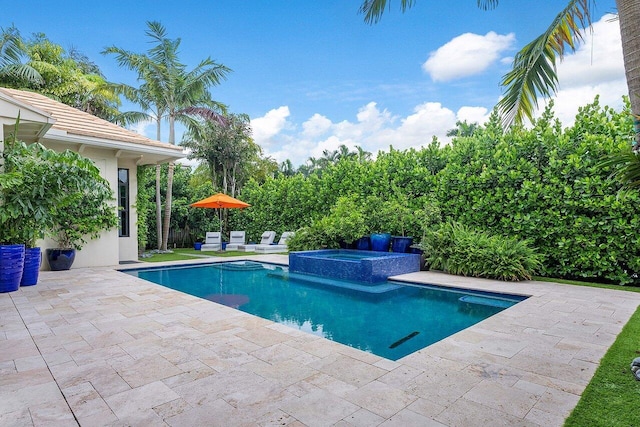 view of swimming pool featuring a patio area and a pool with connected hot tub