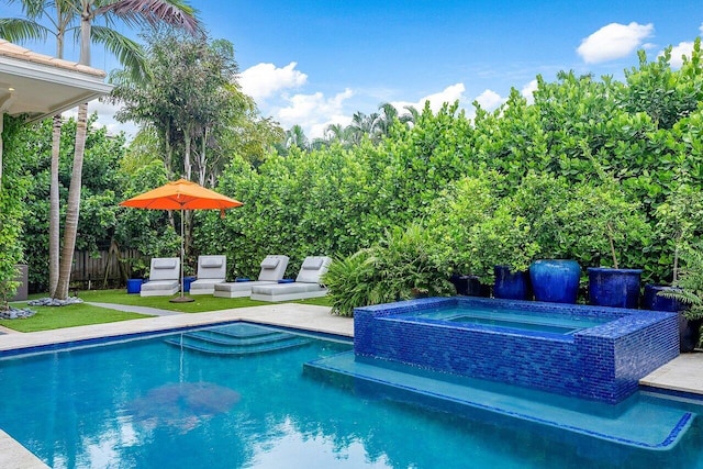 view of swimming pool featuring fence, a fenced in pool, and an in ground hot tub