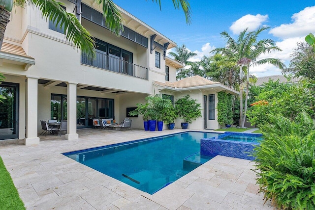 view of pool featuring a patio area and a pool with connected hot tub