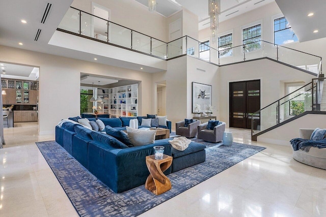 living room featuring baseboards, stairs, visible vents, and recessed lighting