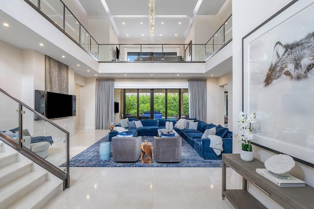 living area with recessed lighting, stairway, light tile patterned floors, and a high ceiling