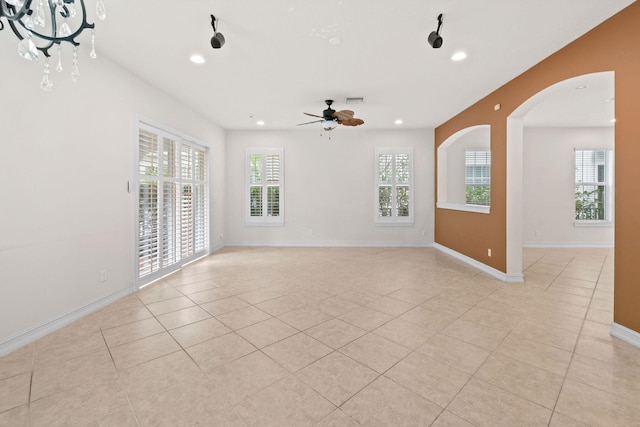 tiled spare room featuring ceiling fan