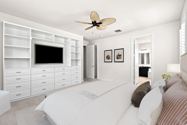 bedroom with connected bathroom, ceiling fan, and light colored carpet