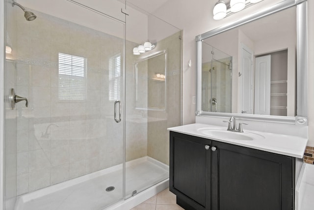 bathroom with vanity, an enclosed shower, and tile patterned floors