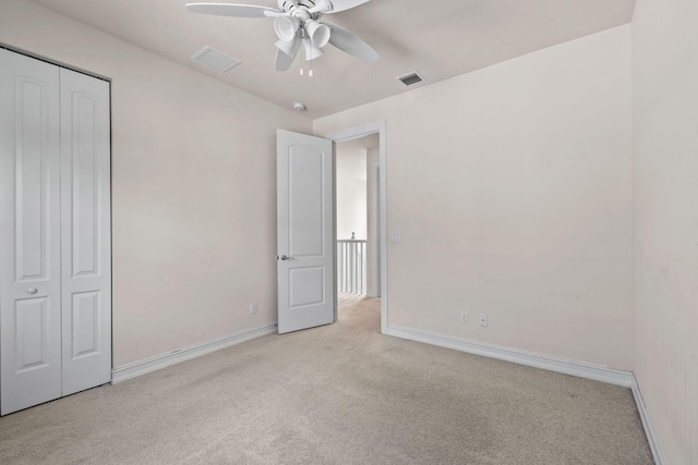 unfurnished bedroom featuring a closet, ceiling fan, and light carpet