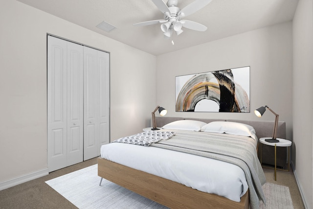 carpeted bedroom featuring a closet and ceiling fan