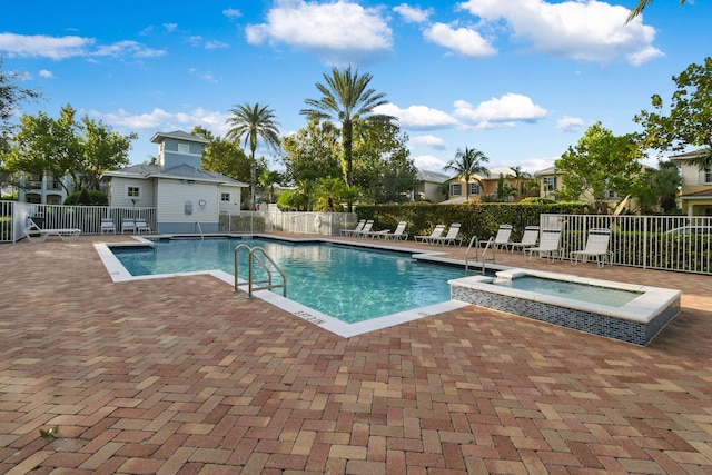 view of swimming pool featuring a patio and a community hot tub