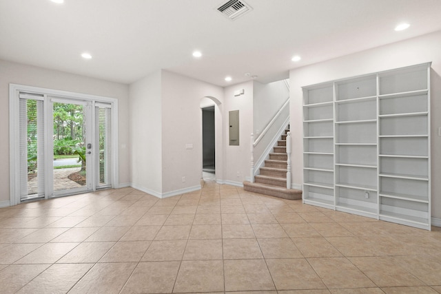 tiled empty room featuring electric panel