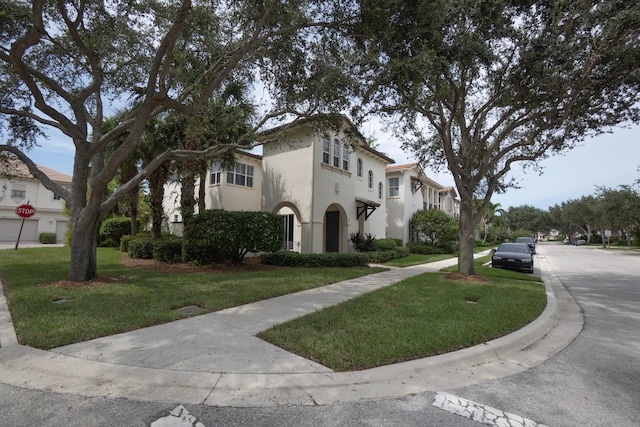 view of front of property featuring a garage and a front yard