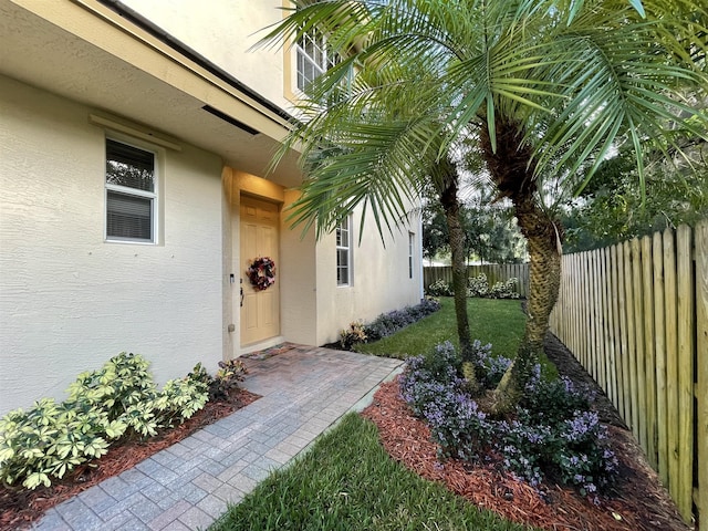 entrance to property with a lawn