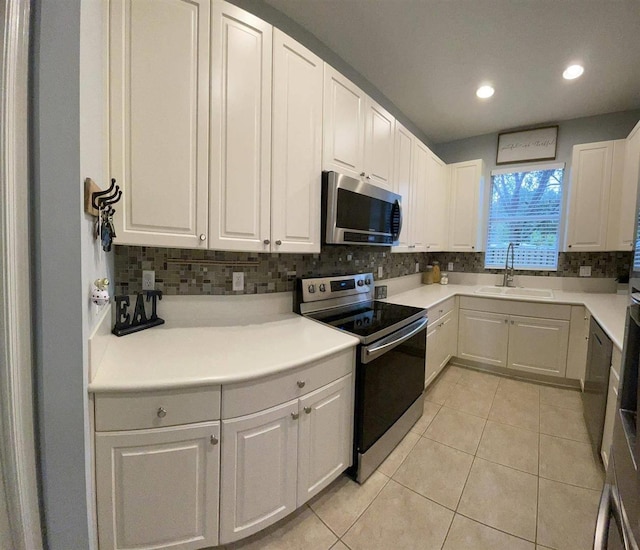 328 SE Bloxham Way, Stuart, FL 34997 - kitchen featuring stainless steel appliances, a sink, tasteful backsplash, recessed lighting, and light tile patterned flooring