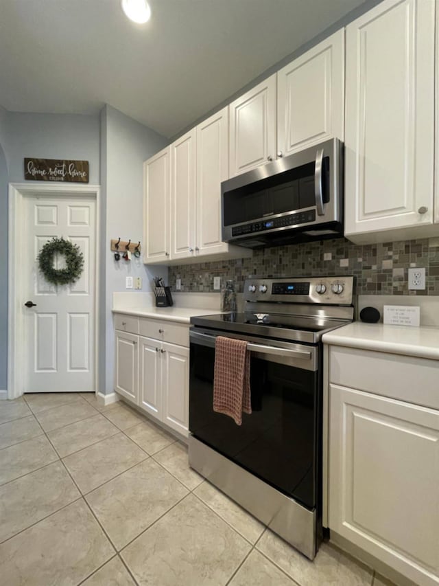 328 SE Bloxham Way, Stuart, FL 34997 - kitchen featuring appliances with stainless steel finishes, decorative backsplash, light countertops, and white cabinetry