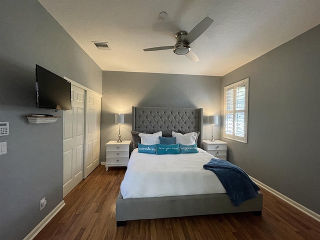 bedroom with dark hardwood / wood-style floors and ceiling fan