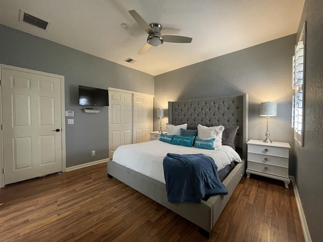 bedroom with ceiling fan and dark wood-type flooring