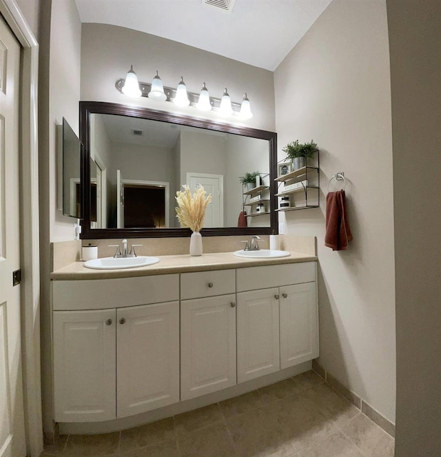 328 SE Bloxham Way, Stuart, FL 34997 - bathroom featuring double vanity, tile patterned floors, and baseboards