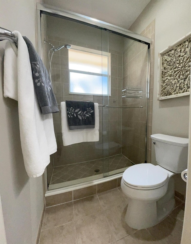 328 SE Bloxham Way, Stuart, FL 34997 - full bathroom featuring toilet, a stall shower, and tile patterned flooring